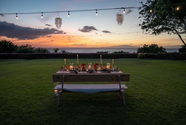 Intimate Maui wedding reception table with string lights at sunset